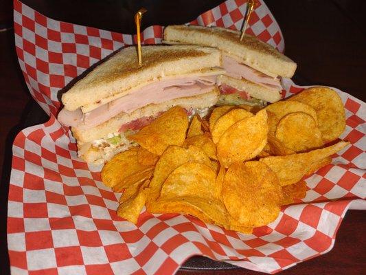 Triple decker turkey sandwich and Lay's BBQ chips