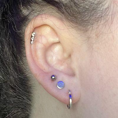 Helix piercing and third lobe piercing.