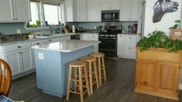 Beautiful kitchen with a soothing pop of color selected by the customer.