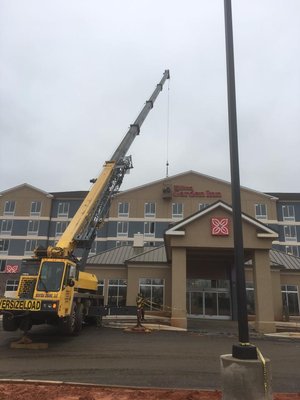 Putting up letters using man basket in Statesville, NC