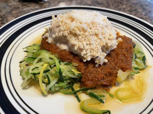 Chicken Parmesan with homemade tomato sauce on top up spiralized zucchini and summer squash