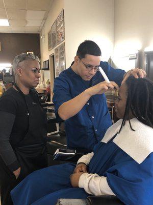 Student being supervised while arching eyebrows.