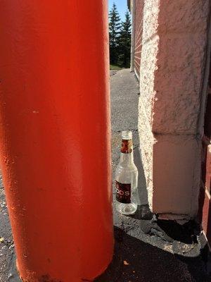 Beer bottle by door.