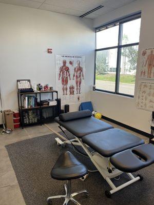 Chiropractic treatment room. Large table to rehab therapies and dry needling with ease