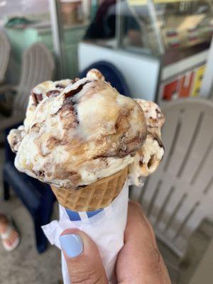 Turtle ice cream in a sugar cone.