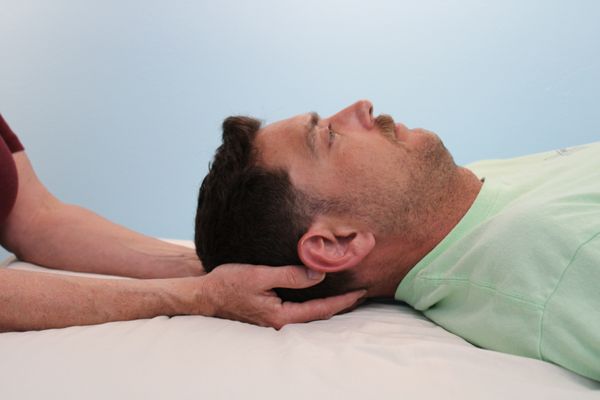 Man receiving craniosacral therapy