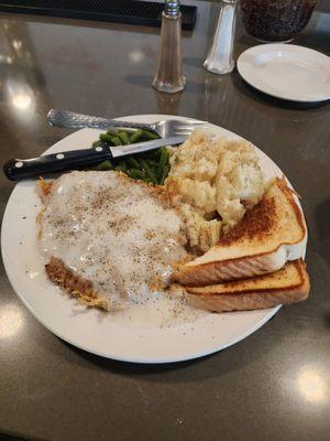 Chicken fried steak, green beans and garlic mashed potatoes with Texas toast.