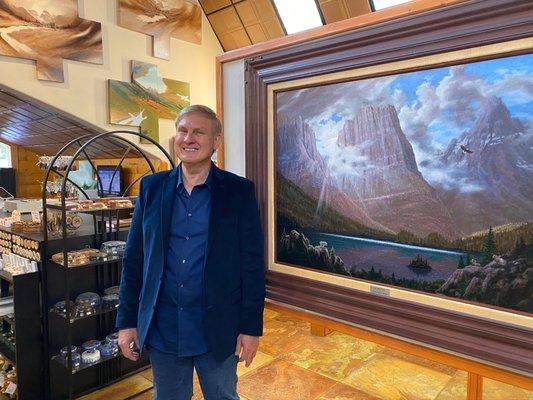 Artist Michael Booth with original oil painting of St. Mary Lake.