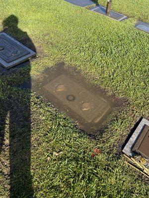 Completely flooded headstone, dirt and sediment all over