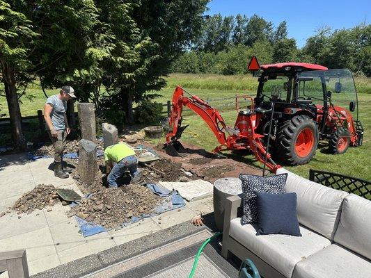 Digging up a decade old (incredibly heavy) basalt column water feature to replace the lines and pump.