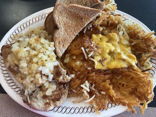 Pork chop dinner smothered with onions and hash browns smothered and covered cooked well!