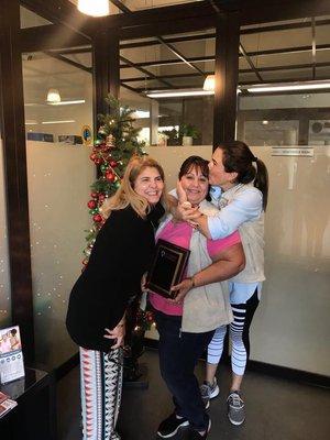 Maria Arias (HR) and Lucy Robelo (owner) hugging the winner of Caregiver of the year!