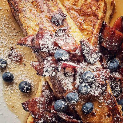 Brioche French Toast with Applewood smoked bacon, blueberries and maple syrup.