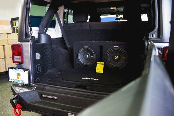 Custom kicker comp r 12s in a Jeep Wrangler Sport.