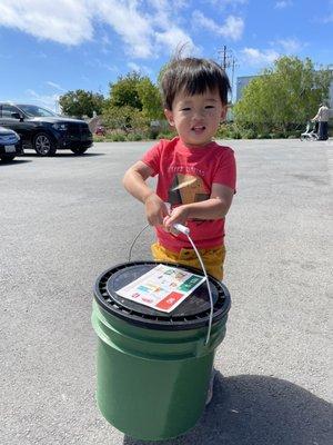 my little helper turning in our compost bin for veggie cash!