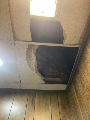 Old worn broken ceiling tiles before being replaced