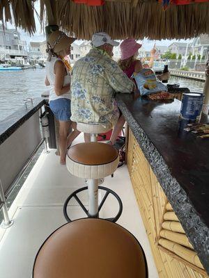 A nice comfortable seat at a floating moving Tiki Bar