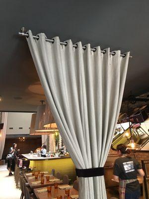 These Grommet top Drapery worked well as a divider in this restaurant.  The ceiling mounted rod gave it a very Modern feel.