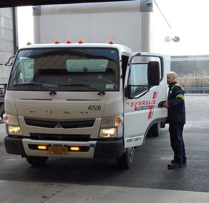 Technician moving truck for service