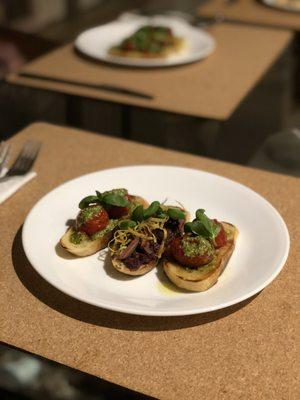 Vegan Starter: Bruschette: roasted tomato and pesto; olive tapenade, fresh olives & lemon zest