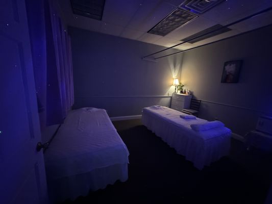 Relax in our serene massage room with comfortable beds, soft lighting, and stress-relieving ambiance.