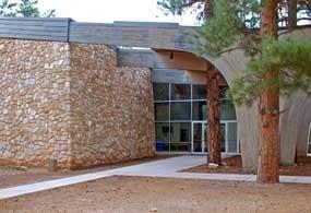 The side entrance is usually unlocked for programs & services. It faces the Pioneer Cemetery.