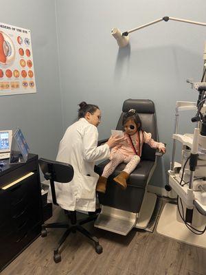 Dr.Vang doing an eye exam on my daughter.