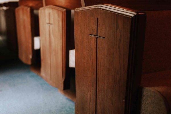 Old wooden pews (with cushions).