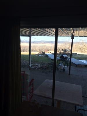 Looking out from the living room to the covered deck and river