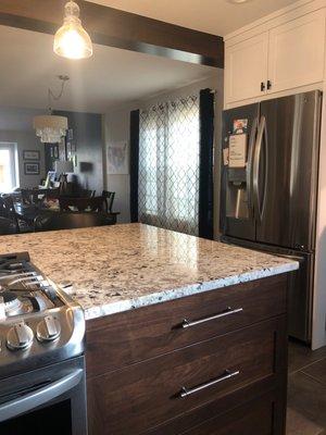 Exposed beams stained to match new kitchen cabinets.