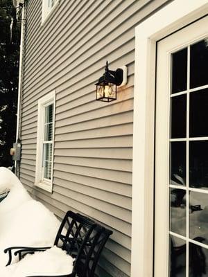 Completed outdoor carriage light installation. The same fixture was also installed in a matching spot on the right hand side of the door.