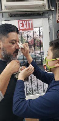 My son cleaning his dad's face after their fresh cuts.