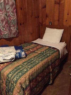 The smaller room inside cabin 9 with the twin size bed