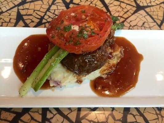 Amazingly delicious 24-hour braised short rib over red skin mashed potatoes with asparagus, topped with   A roasted tomato. Yum!