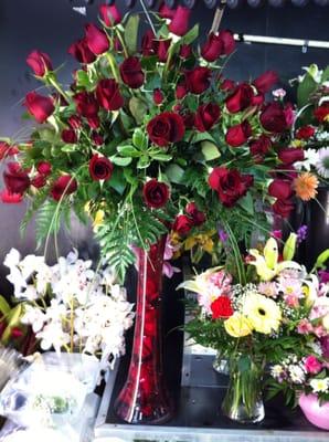 Wedding Centerpiece of all Red Roses in a tube w/ red roses petals