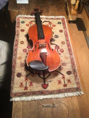 My violin getting some finishing touches on Jesse's work station.