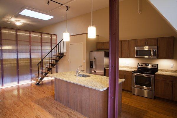 Typical Kitchen with Granite-Top Island, Stainless Steel Appliances.