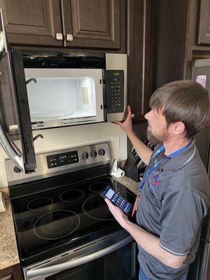 Our tech, Billy, servicing a microwave.