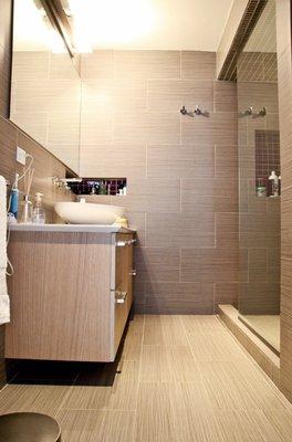 Renovated bathroom, wall tile, floor tile , vanity cabinet and sink, walk in - new glass shower