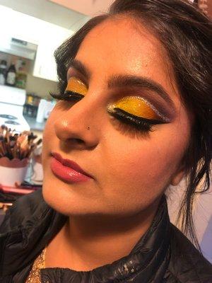 A yellow cut crease and natural face glam on a client for a wedding.