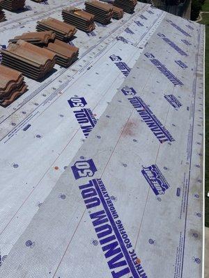 Lift and Relay; Lift existing tiles and set aside to install the Underlayment 
Photo 2 of 4