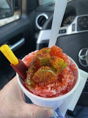 Pickdilly(off menu) Cherry Snowcone topped with pickle chunks, chamoy sauce and sprinkled with tajin