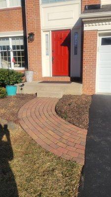 Old plain cement stoop with narrow step and brick pavers