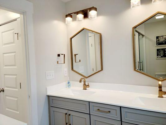 Upstairs main bedroom bath with double vanity, shower, and toilet.