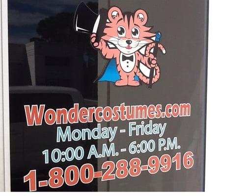 Wonder Costumes front door with logo and business info.