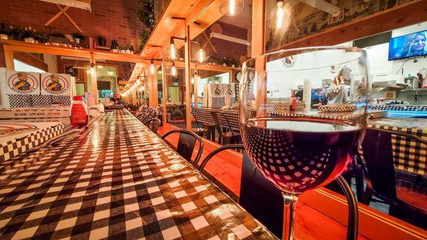 Red wine and cool infinity mirror in warm/cozy interior