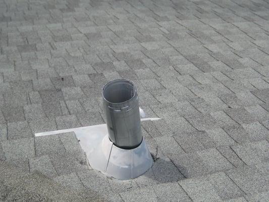 Open furnace vent flashing on roof.  Missing flue termination cap.