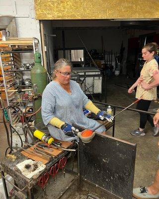 Kristie Burton shaping her glass bowl.