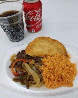 Pepper Steak, yellow rice & a beef empanada with a soda on the side