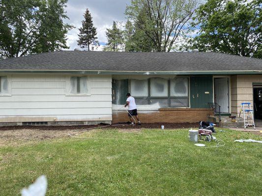 Painting an exterior house in Brooklyn Park, MN.